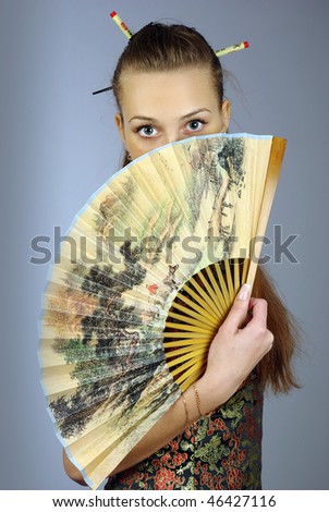 Beautiful young woman with fan