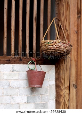 Bamboo basket and plastic barrel on the wall.