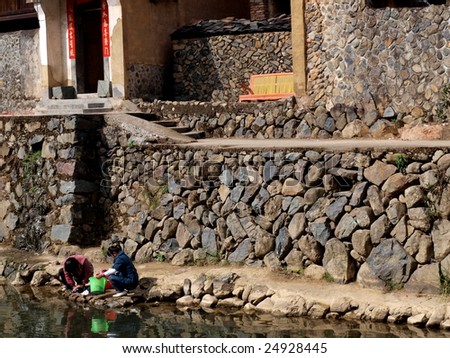 Village landscape. In the morning, villagers washing clothes by the river.
