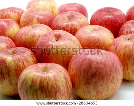 Lots of red and yellow apples on white background.