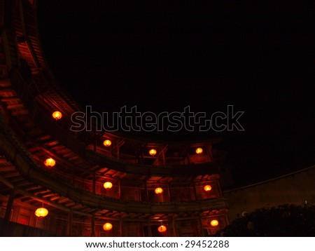 Red lanterns lighting the Chines old building in the Earth Tower of Hakka, Fujina, China.