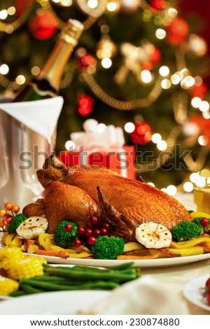 Christmas Turkey served for Christmas dinner in front of a Christmas tree