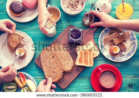 Young Happy Family Having Breakfast