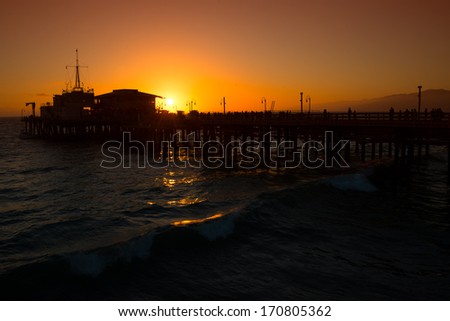 Silhouette of a pier in the Pacific ocean at dusk, Santa Monica Pier, Santa Monica, Los Angeles County, California, USA
