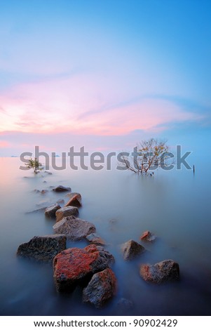 Rock formation in leading line composition towards sunset direction