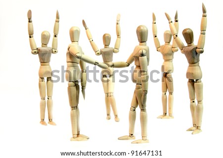 A group of people (wooden doll) cheering when two person shake hand depicting a deal or agreement