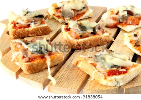 Homemade healthy cutie pizza bread on top of wooden cutting board on white