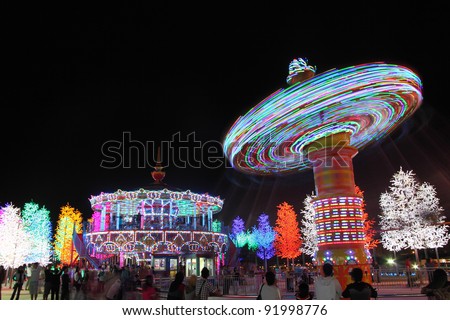 SHAH ALAM, MALAYSIA - DECEMBER 31 : Crowd stroll around in the colourful night theme park as they wait for New Year firework celebration on December 31, 2011 in ICT City, Shah Alam, Selangor, Malaysia