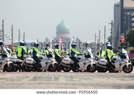 PUTRAJAYA, MALAYSIA - FEB 24 : Police traffic marshals queue to escort cyclist during the  Putrajaya Time Trial which is the first stage of Le Tour de Langkawi 2012 on Feb 24, 2012 in Putrajaya, Malaysia