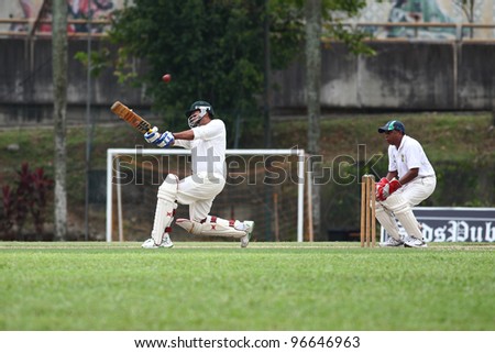 KUALA LUMPUR, MALAYSIA - MARCH 3: Unidentified batsman hits the ball during a friendly match between Royal Selangor Club and Silver State Cricket Club on March 3,1012 in Kuala Lumpur, Malaysia