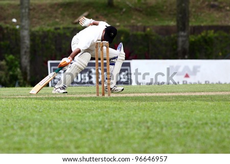 KUALA LUMPUR,MALAYSIA - MARCH 3: Unidentified batsman runs & touches the crease during a friendly match between Royal Selangor Club and Silver State Cricket Club on March 3,1012 in K. Lumpur, Malaysia
