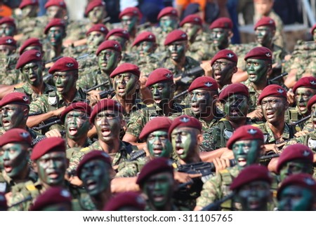 KUALA LUMPUR -  Aug 29 : Troops from the Royal Malaysian Armed Forces give salute to the VIP area during full rehearsal for National Day parade on Aug 29,2015 at Dataran Merdeka, Kuala Lumpur,Malaysia