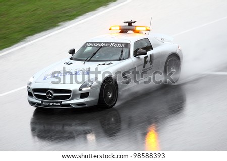 SEPANG, MALAYSIA - MARCH 25: Safety car lead the Formula One racer during heavy rain downpour in Formula One PETRONAS Malaysian Grand Prix at Sepang F1 circuit on 25 March, 2012 in Sepang, Malaysia