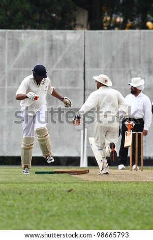 KUALA LUMPUR, MALAYSIA - MARCH 3: Unidentified batsman runs & touches the crease during a friendly match between Royal Selangor Club and Silver State Cricket Club on March 3, 2012 in K. Lumpur, Malaysia