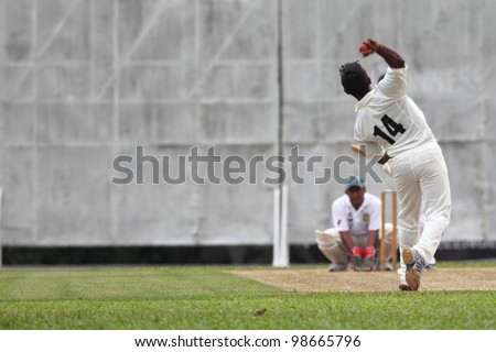 KUALA LUMPUR, MALAYSIA - MARCH 3 : Unidentified bowler throws a ball during a friendly match between Royal Selangor Club and Silver State Cricket Club on March 3, 2012 in K. Lumpur, Malaysia