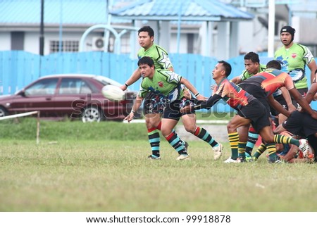 KUALA LUMPUR-APRIL 8:Unidentified ATM RAMD player passes the ball during a Malaysian Rugby Union(MRU) Super League match against Keris Conlay on April 8,2012 in Kuala Lumpur,Malaysia. Conlay won 29-12