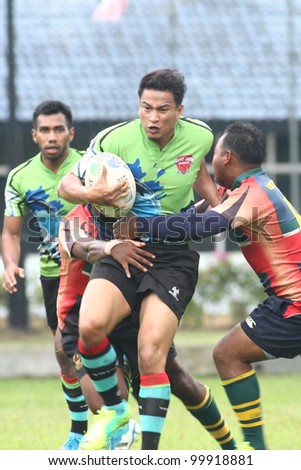 KUALA LUMPUR-APRIL 8: Two ATM RAMD players blocks an unidentified  Keris Conlay player during a Malaysian Rugby Union(MRU) Super League match on April 8, 2012 in Kuala Lumpur.Malaysia.Conlay won 29-12