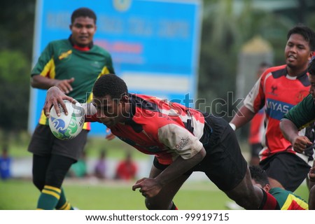 KUALA LUMPUR - APRIL 1: Unidentified ASAS player attempt a try touchdown during a Malaysian Rugby Union Super League match against ATM RAMD on April 1, 2012 in Kuala Lumpur, Malaysia. ASAS won 27-25