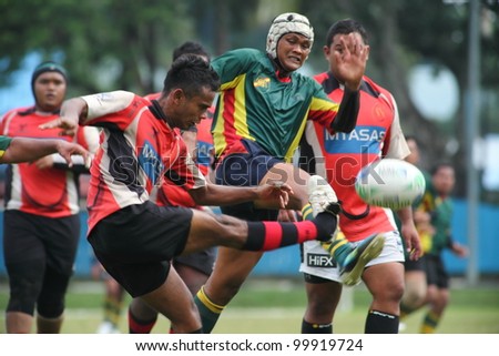 KUALA LUMPUR - APRIL 1: Unidentified ASAS player kick the ball during a Malaysian Rugby Union (MRU) Super League match againts ATM RAMD on April 1, 2012 in Kuala Lumpur, Malaysia. ASAS won 27-25