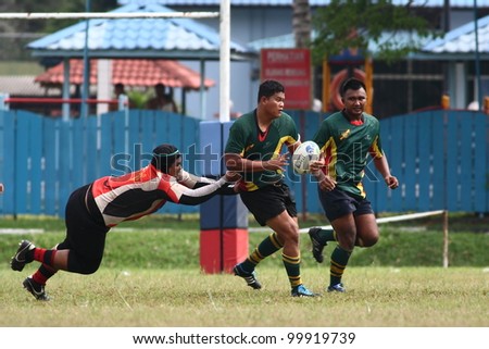 KUALA LUMPUR - APRIL 1:Unidentified ASAS player passes the ball during a Malaysian Rugby Union(MRU) Super League match against ATM RAMD on April 1, 2012 in Kuala Lumpur, Malaysia. ASAS won 27-25