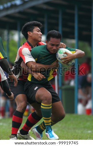 KUALA LUMPUR - APRIL 1 : Unidentified ASAS player blocks a ATM RAMD player during a Malaysian Rugby Union(MRU) Super League match on April 1, 2012 in Kuala Lumpur, Malaysia. ASAS won 27-25