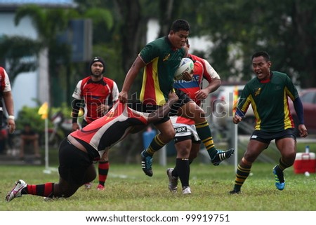 KUALA LUMPUR - APRIL 1:Unidentified ASAS player try to blocks a ATM RAMD player during a Malaysian Rugby Union(MRU) Super League match on April 1, 2012 in Kuala Lumpur, Malaysia. ASAS won 27-25