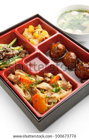 Japanese Meal in a Box (Bento) - Meat Cutlets and Noodles with Cucumbers Salad and Dessert