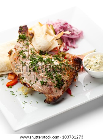 Grilled Chicken with Lavash, Vegetables and Pickled Onions. Garnished with Tartar Sauce
