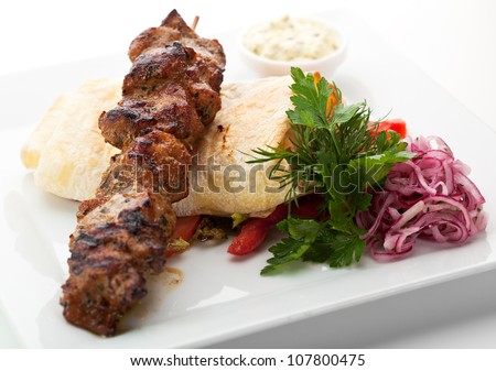 Hot Meat Dish - Grilled Meat with Pickled Onions, Lavash, Vegetables and Red Spicy Sauce