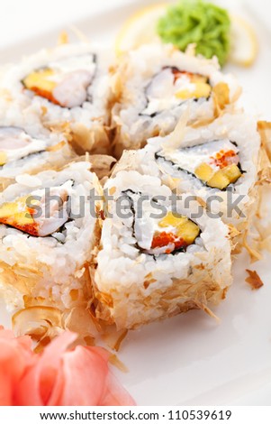Salmon Skin Maki Sushi - Roll with Scallop, Cream Cheese and Pineapple inside. Grilled Salmon Skin outside