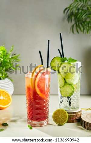 Mango, Grapefruit, Cucumber and Lime Lemonade with Mint Leaves in Glasses Close Up. Set of Summer Refreshing Cold Drinks or Beverages with Fruits, Ice, Natural Juice, Water and Sugar Close Up