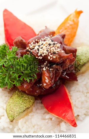 Beef Fried in Sour-Sweet Sauce. Garnished on Sliced Vegetable and Rice