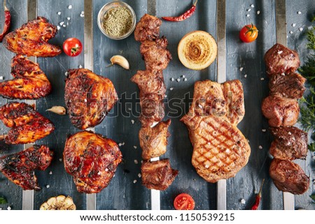 Big Set of Restaurant Grill Menu with Skewers of Chicken, Pork, Lamb and Beef on Luxury Black Stone Top View. Barbecue Buffet with Fresh Greens, Spices and Grilled Vegetables Flat Lay