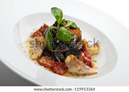 Black Spaghetti with Sea Bass and Batarga (dried, salted, pressed red roe) and Dried Cherry Tomato. Served with Fresh Corn Salad Leaves