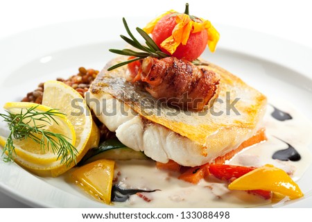 Fried Fish (Zander) with Bacon. Garnished with Lemon,  Lentil and Vegetables