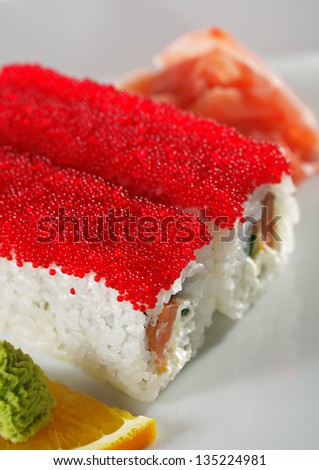 Maki Sushi with Fresh Salmon, Cucumber and Cream Cheese inside. Topped with Red Tobiko (flying fish roe)