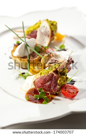 Roasted Lamb Chops with Pistachio. Garnished with Eggplant and Artichoke