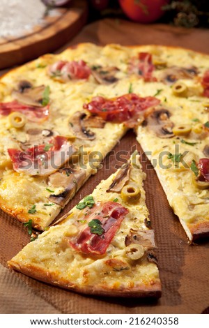 White Pizza made from Sour Cream Sauce, Mushrooms, Bacon and Mozzarella Cheese
