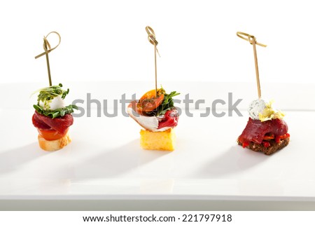 Meat and Vegetables Canapes over White