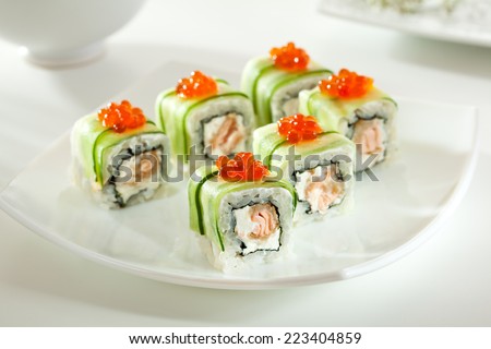 Maki Sushi - Rolls with Fried Salmon and Cream Cheese insisde. Cucumber outside. Topped with Salmon Caviar