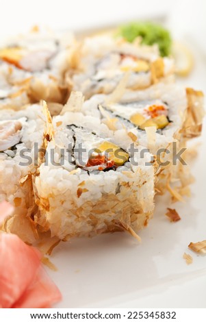 Salmon Skin Maki Sushi - Roll with Scallop, Cream Cheese and Pineapple inside. Grilled Salmon Skin outside