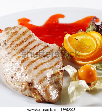 Chicken Grilled Steak with Sauce and Orange Slice. Isolated on White Background
