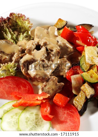 Stewed Beef with Vegetables and Fresh Vegetable on Plate. Isolated on White Background