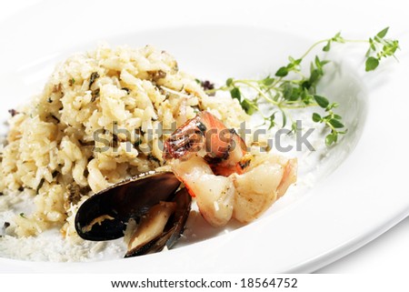Shrimp and Scallop Risotto Served with Green. Isolated on White Background