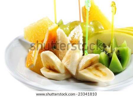 Fresh Sliced Fruit Plate (Banana, Kiwi, Pineapple, Apple, Grapes). Isolated on White Background