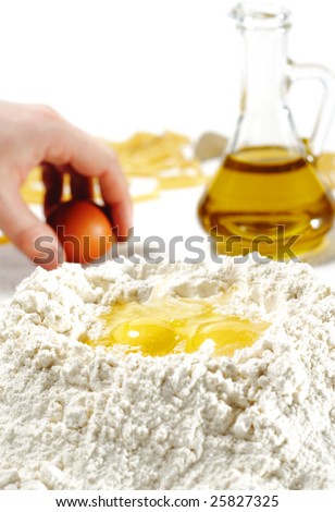 Flour Heap and Egg with Olive Oil on a Background. Focus on Foreground