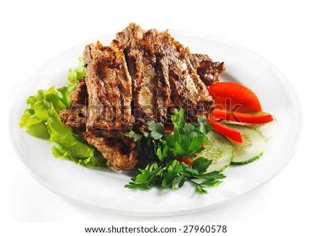 Hot Meat Dishes - BBQ Meat with Fresh Vegetables and Salad Leaf. Isolated on White Background