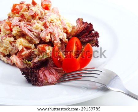 Salad Comprises Smoked Foods, Tomato and Cheese Dressed with Red Salad Leaves and Tomato. Isolated on White Background
