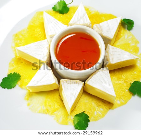 Fromage (Soft Cheese) with Honey Orange Sauce and Fresh Pineapple. Isolated on White Background