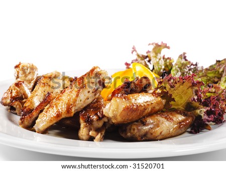 Hot Meat Dishes - Fried Chicken Wings with Orange Slice and Vegetable Leaf